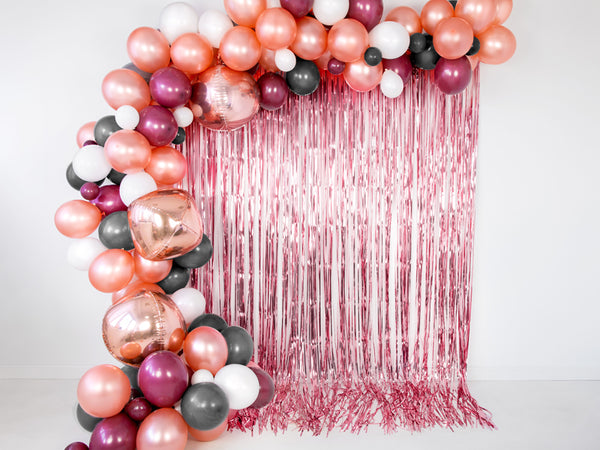Rose Gold Fringe Curtain Party Backdrop perfect for a photo backdrop available at A Little Confetti